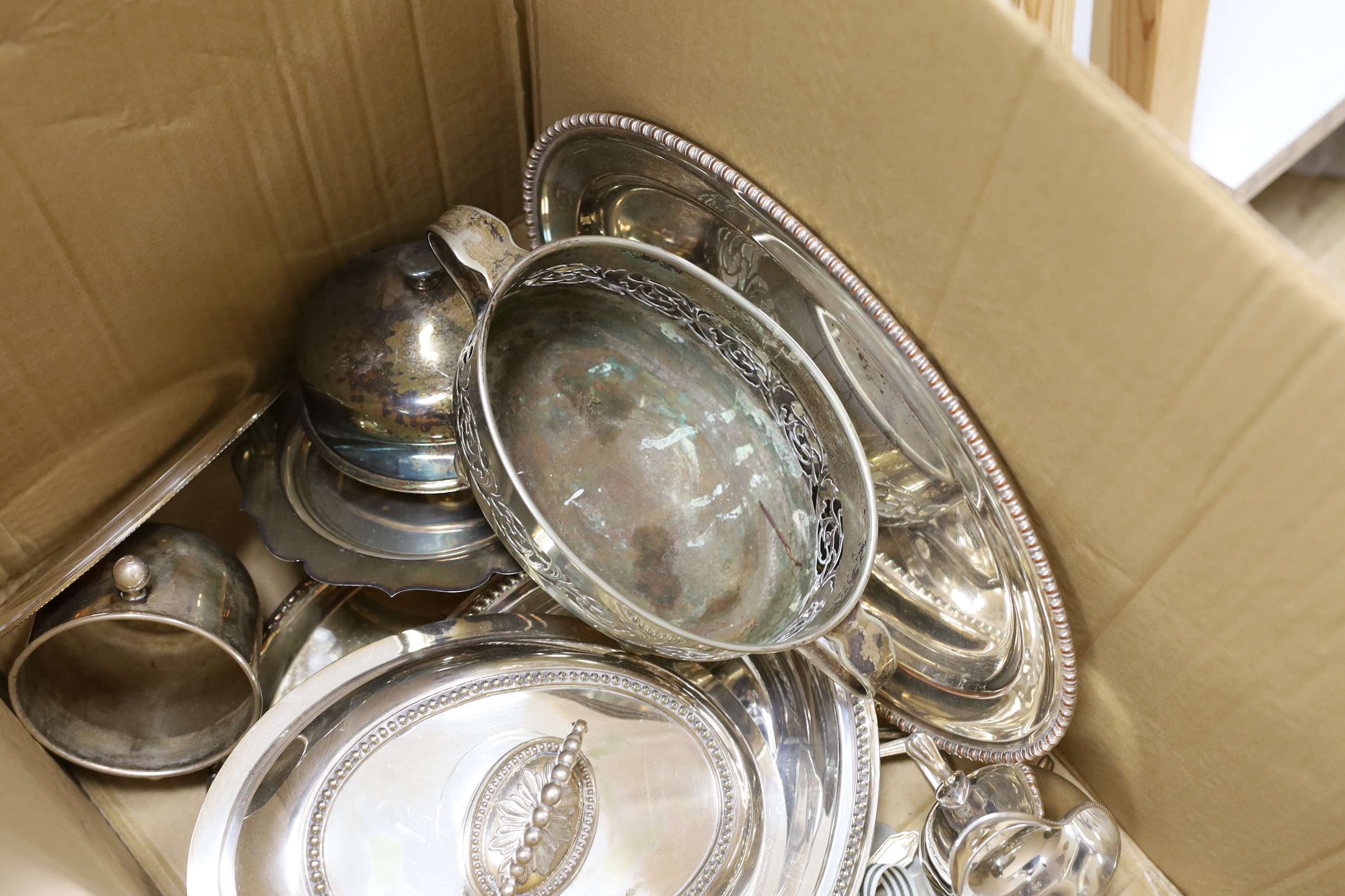 A small collection of plated wares, including an oval tray, an entree dish and cover, cutlery etc.